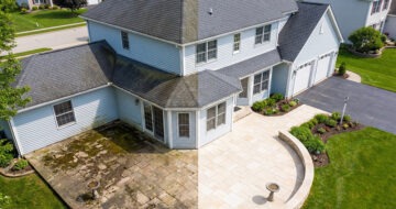 House half cleaned. Roof, siding, windows, patio, and driveway.